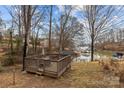 Picturesque backyard featuring a wooden deck with outdoor furniture, overlooking a serene lake with boat docks at 221 Island Terrace Rd, Statesville, NC 28677