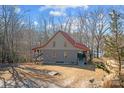 Exterior view of a gray and red home showcases a cozy covered porch and inviting curb appeal at 221 Island Terrace Rd, Statesville, NC 28677