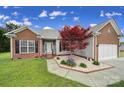 Charming single-Gathering home featuring a well-manicured lawn and a vibrant red maple tree at 2880 Harmony Rd, Rock Hill, SC 29730