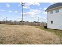 Expansive backyard enclosed by a wooden fence, offering plenty of open space and privacy, as well as some mature trees at 305 Wingate Ct, Shelby, NC 28152