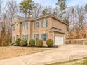 Charming brick home featuring an attached garage and mature trees in a serene setting at 3704 Bronte Ln, Monroe, NC 28110