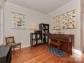 Bright office space with hardwood floors, piano, and built-in shelving at 471 M St, Charlotte, NC 28204