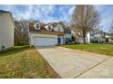 Beautiful two-story home showcasing a lush green lawn and long driveway leading to an attached garage at 5707 Brandy Ridge Ln, Charlotte, NC 28269