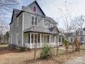Angle view of a two-story home showcasing its architecture and surrounding landscape at 613 S Mulberry St, Statesville, NC 28677