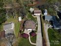 Stunning aerial view showcasing the home's unique dome design, landscaping, and spacious driveway at 7977 Lucky Creek Ln, Denver, NC 28037