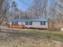 Charming home featuring a blue roof, new deck, and manicured landscaping at 1075 Fye Dr, Newton, NC 28658