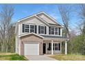 Charming two-story home featuring a brick-accented garage and a welcoming front porch with great curb appeal at 1116 Thayer Glen Ct, Charlotte, NC 28213