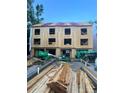 Construction site displaying the exterior framing of a new three-story townhouse complex at 115 Verbena Ne St # 12, Charlotte, NC 28217