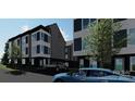 Contemporary townhome with clean lines, complemented by a well-maintained lawn and community atmosphere at 115 Verbena Ne St # 12, Charlotte, NC 28217