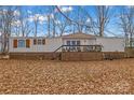 Single-wide mobile home with wood deck and wooded lot at 1789 Paris Dr, Conover, NC 28613