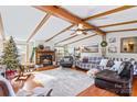 Spacious living room with exposed beams, fireplace, and large windows at 1789 Paris Dr, Conover, NC 28613