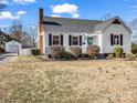 White house with black shutters, landscaped yard, and a blue door at 201 Ware St, Shelby, NC 28150