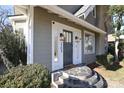 Close-up of the elegant front door with stone steps, featuring stylish lighting fixtures and clear numbering at 2304 Dilworth W Rd, Charlotte, NC 28203
