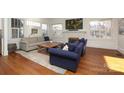 Bright living room with hardwood floors, a cozy fireplace, and an abundance of natural light at 2304 Dilworth W Rd, Charlotte, NC 28203