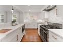 The renovated kitchen features stainless steel appliances, stone countertops, custom cabinetry, and a modern design at 2809 Glendale Rd, Charlotte, NC 28209