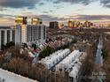 Stunning aerial view of a neighborhood with modern condos and the city skyline at sunset at 287 Mcdonald Ave, Charlotte, NC 28203