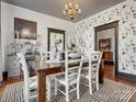 Inviting dining area with patterned wallpaper, dark trim, and a view into the kitchen at 331 E White St, Rock Hill, SC 29730