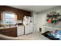 Functional kitchen area with wood cabinets, a window, and essential appliances at 3331 Tamworth Ln, Gastonia, NC 28052