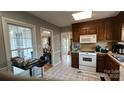 Efficient kitchen with appliances, wood cabinets, and an open view of the living area at 3331 Tamworth Ln, Gastonia, NC 28052
