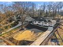 Expansive aerial view of a home showcasing the well-maintained lawn, long driveway, and nearby houses at 5630 Timber Ln, Charlotte, NC 28270