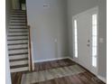 Welcoming foyer with staircase, hardwood floors and bright natural light at 5934 Hickory Hollow Ct, Harrisburg, NC 28075