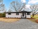 Charming renovated home featuring a painted brick facade, dark accents, and new landscaping at 7514 Highway 205 Hwy, Marshville, NC 28103