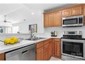 Bright kitchen featuring wood cabinets, stainless steel appliances, and white countertops at 753 Southwest Dr, Davidson, NC 28036