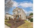 Beautiful two-story home with a cozy front porch and manicured lawn at 7602 Rolling Meadows Ln, Huntersville, NC 28078