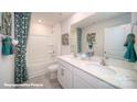Bright bathroom featuring double sink vanity, shower-tub combo and modern finishes at 8032 Plymouth Dr, Sherrills Ford, NC 28673