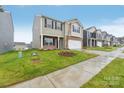Street view of new two-story homes with brick accents, siding, garages and landscaped lawns at 8032 Plymouth Dr, Sherrills Ford, NC 28673