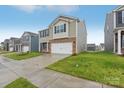Two-story home with brick and siding, featuring a two-car garage and well-maintained landscaping at 8032 Plymouth Dr, Sherrills Ford, NC 28673