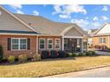 Brick home with screened porch and landscaping at 8466 Benton Ct, Denver, NC 28037