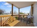 Covered porch with wooden railing, chairs, and plants at 87 Firemens Ln, Taylorsville, NC 28681