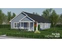 Single-story home featuring light blue siding, a welcoming front porch, and a well-maintained lawn at 0 Shaver St # 3, Salisbury, NC 28144