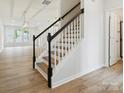 Elegant staircase with wood treads, black rails, and white risers in a naturally lit home at 10115 Mamillion Dr, Huntersville, NC 28078