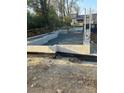 Newly constructed foundation block walls filled with gravel, surrounded by construction materials and dirt at 111 Verbena Ne St # 10, Charlotte, NC 28217