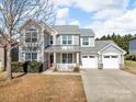 Beautiful two-story home with attached two car garage, covered porch, and manicured landscaping at 1148 Mckee Farm Ln, Belmont, NC 28012