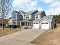 Charming two-story home with a two-car garage and covered porch, perfect for enjoying the outdoors at 1148 Mckee Farm Ln, Belmont, NC 28012