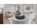 Cozy living room with natural light, neutral tones, and comfortable seating arrangement at 122 Lansdowne Rd, Charlotte, NC 28270