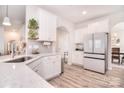 A bright, modern kitchen with white cabinets, an island, and stainless steel appliances at 124 Doncaster Dr, Mooresville, NC 28115