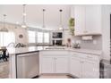 A modern, open-concept kitchen features an island, stainless steel appliances, and seamless access to the living area at 124 Doncaster Dr, Mooresville, NC 28115