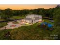 Expansive property featuring a modern home, playground, and meticulously maintained landscaping, providing a luxurious outdoor lifestyle at 15700 Youngblood Rd, Charlotte, NC 28278