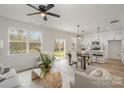 Open living area with kitchen and dining area, hardwood floors, and access to backyard at 3004 Sadler Woods Ln, Charlotte, NC 28214
