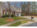 Well-maintained home with a lush lawn, mature trees, and a long driveway leading to an attached two-car garage at 3302 Cole Mill Rd, Charlotte, NC 28270