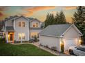 A spacious home exterior showcases a well-maintained yard, brick pathway, and detached garage with parking space at 375 Montibello Dr, Mooresville, NC 28117