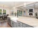 Modern kitchen featuring stainless steel appliances, farmhouse sink, and an adjacent dining area at 4021 Harmattan Dr, Denver, NC 28037