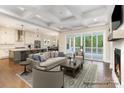 Bright, open-concept living room with fireplace and hardwood floors at 4021 Harmattan Dr, Denver, NC 28037
