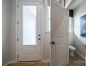 Front entry with powder room and neutral color palette at 8016 Lerwick Trl, Charlotte, NC 28269