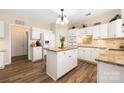Well-lit kitchen with an island, breakfast bar, and stainless steel appliances at 8851 Glenside St, Huntersville, NC 28078