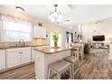 Open-concept kitchen with an island, breakfast bar, and view into the living room at 8851 Glenside St, Huntersville, NC 28078
